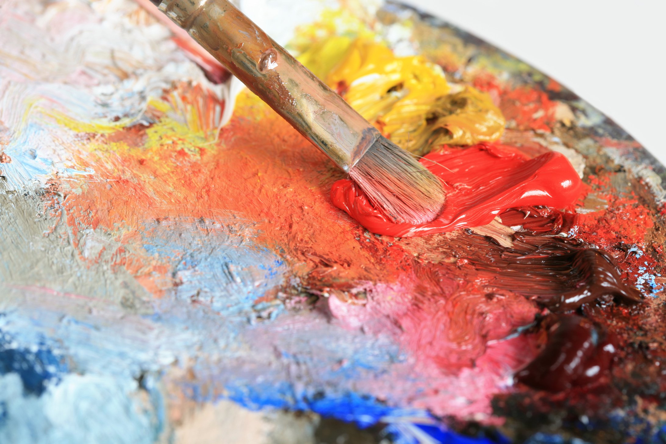 Paintbrush with oil paint on a classical palette