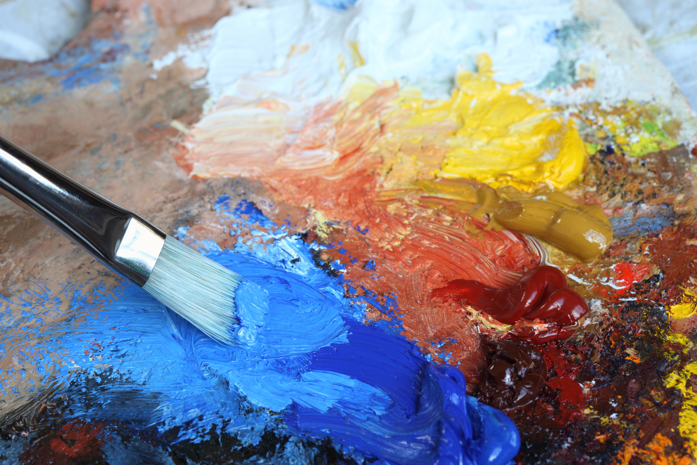 Paintbrush with Cobalt blue oil paint on a classical palette